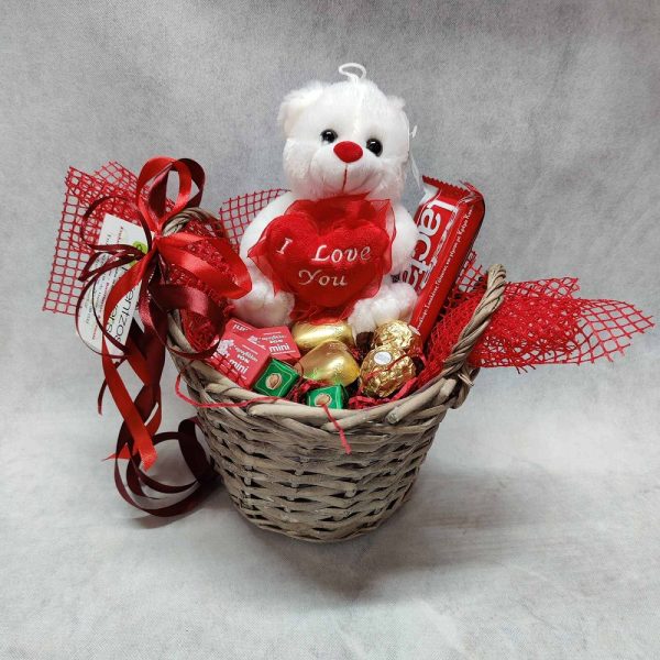 valentines present a basket with chocolate and love teddy bear
